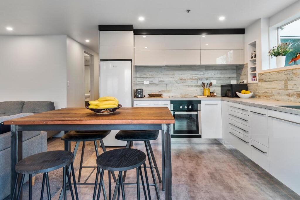 Modern kitchen with dining table in the Tauranga apartment